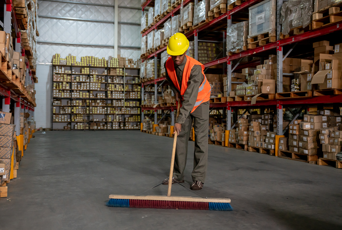 Worker cleaning storage area